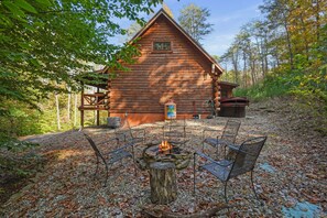 A log cabin with a fire pit and outdoor seating. - Sandstone Oasis | Hocking Hills, Couples, Hot Tub (Logan)