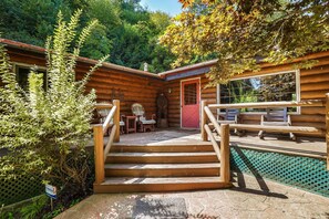 A wooden cabin with a stone staircase leading to a deck area. - Diamond In The Rough | Waterfall & Rock Wall (Rockbridge)