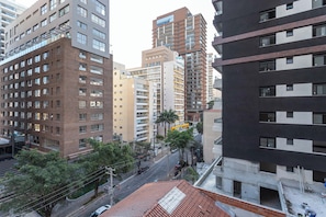 A multi-story building with a mix of residential and commercial spaces, featuring a variety of architectural styles and a central courtyard.