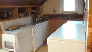 A compact kitchen with white cabinetry, a sink, and a window above the counter. - ATI Chalet-style apartment from the 1800s in the heart of Ortisei (Ortisei)