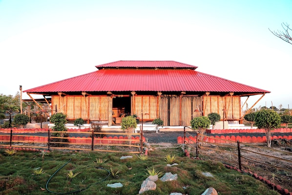 A traditional building with a red roof, wooden pillars, and a covered entrance. - The Restfo Pench Tiger Resort (Ramtek)