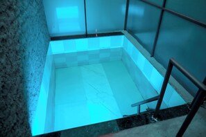 A swimming pool with a tiled interior, surrounded by walls and a metal railing. - The Restfo Pench Tiger Resort (Ramtek)