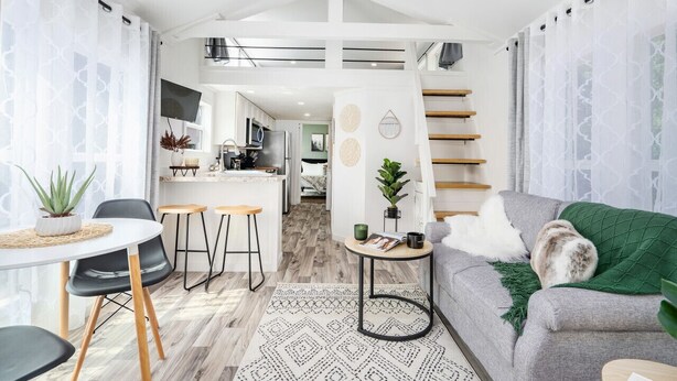 A modern living space with a kitchen, dining area, and a staircase. - Cozy Tiny Cabin Near Lake Guntersville (Guntersville)