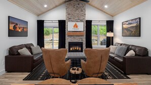 A living room with a fireplace, two leather sofas, a stone wall, and a fireplace logo.