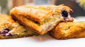 Primer plano de un pastel con trozos de fruta visibles, probablemente un postre o repostería.