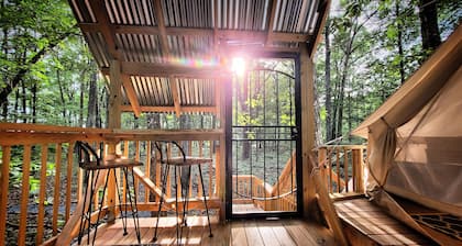 Mountain Bell tent Tree house providing views of surrounding mountains and lake.