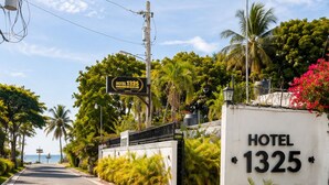 A road leading to a hotel entrance with a sign reading 'HOTEL 1325'. - Hotel 1325 (Bani)