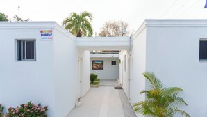 A narrow hallway with a sign for Hotel 1235, leading to a door. - Hotel 1325 (Bani)