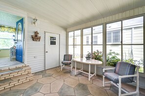 Step into a charming outdoor space with a round table and comfortable seating.