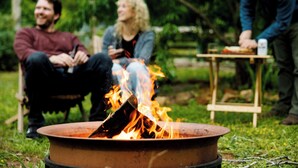 A group of people around a campfire in an outdoor setting. - The Cabins at Reverence Farms by Sagra (Graham)