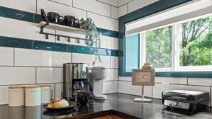 A kitchen with a coffee maker, a tea kettle, and a sign that reads "Coffee Bar". - Cozy Lake Retreat (Honeoye)