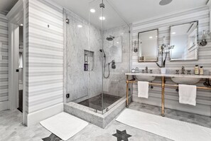 A modern bathroom with a glass-enclosed shower, marble flooring, and a vanity with multiple sinks and mirrors. - Gorgeous, Peaceful Sanctuary on lake minutes from Boston & all local colleges. (Wayland)