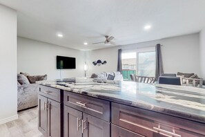 Enjoy meals in this well-equipped kitchen with a large island and flat-screen TV.