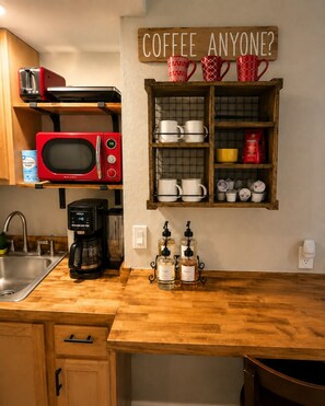 A kitchen with a coffee station, a microwave, a toaster, and a coffee maker. - Beaver Lodge • Green Mountain Fall Escape Near Pikes Peak (Green Mountain Falls)
