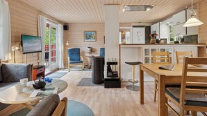 A cozy cabin interior with a living room, dining area, and kitchen. - "Nahuel" - 200m from the sea by Interhome (Nexø)