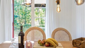 A dining table with a bottle of wine, glasses, a fruit tray, and a rustic wooden box. - "Selvi" - 125m from the sea by Interhome (Nexø)