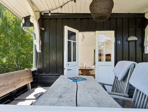 A wooden deck with a table, bench, and chairs. - "Kerstin" - 100m from the sea by Interhome (Nexø)
