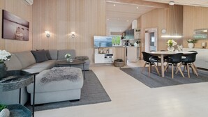 A modern living room with a sofa, coffee table, and dining area. - "Bergulv" - 75m from the sea by Interhome (Nexø)