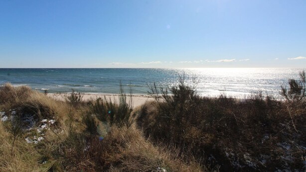 A beach with clear skies and sunlight reflecting off the water. - "Nada" - 200m from the sea by Interhome (Aakirkeby)