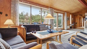 A cozy living room with a wooden ceiling, large windows, and a sofa set. - "Nada" - 200m from the sea by Interhome (Aakirkeby)