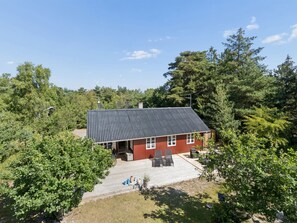 A red building with a dark roof, surrounded by trees and a clear sky. - "Malou" - 350m from the sea by Interhome (Aakirkeby)
