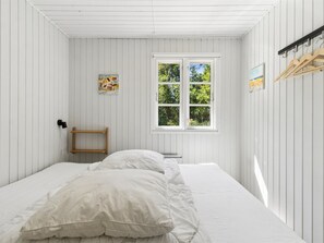 A room with a bed, a window, and a wall-mounted shelf. - "Malou" - 350m from the sea by Interhome (Aakirkeby)