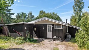 A single-story cabin with a front door, a small porch, and a chimney. - "Essi" - 300m from the sea by Interhome (Aakirkeby)