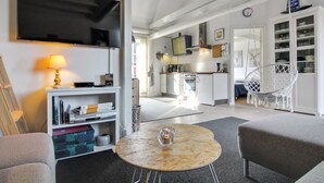 A modern living room with a flat-screen TV, a round coffee table, and a comfortable seating area. - "Gisella" - 6km from the sea by Interhome (Aakirkeby)