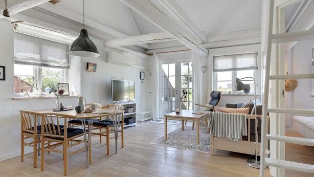 A spacious living room with a dining area, a sofa, and a TV. - "Antine" - 6km from the sea by Interhome (Aakirkeby)