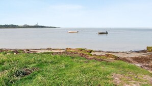 A calm body of water with boats, grassy shore, and distant buildings. - "Makrina" - 175m from the sea by Interhome (Jægerspris)
