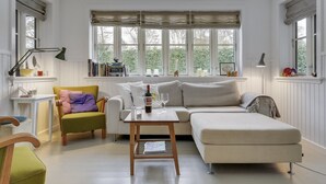 A bright living room with a sofa, armchair, and a coffee table. - "Emely" - 700m from the sea by Interhome (Jægerspris)