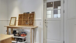 A room with a wooden desk, a shoe rack, and a white door with a glass panel. - "Emely" - 700m from the sea by Interhome (Jægerspris)
