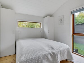 A bedroom with a single bed, a window, and a door. - "Aino" - 1km from the sea by Interhome (Liseleje)