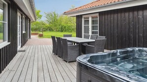 A wooden deck with a hot tub, outdoor furniture, and a view of a garden. - "Ribanna" - 650m from the sea by Interhome (Gilleleje)