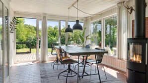 A covered patio with a dining table, chairs, and a fireplace. - "Gritt" - 800m from the sea by Interhome (Gilleleje)