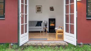 A cozy living room with a fireplace, a sofa, and a coffee table. - "Tabetha" - 25m from the sea by Interhome (Tisvildeleje)