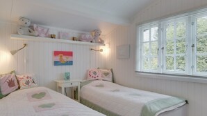 A cozy bedroom with two beds, a shelf with decorative items, a painting, and a window with blinds. - "Ylermi" - 1.5km from the sea by Interhome (Dronningmølle)