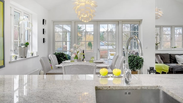 A modern kitchen with a central island, large windows, and a dining area with a sofa. - "Amine" - 700m from the sea by Interhome (Hornbæk)