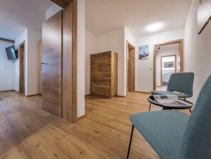 Relax in a calm and inviting space with a comfortable chair, flat-screen TV, and ample storage.