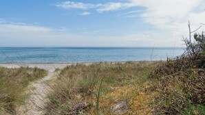 A beach with a clear sky and calm sea. - "Auke" - 100m from the sea by Interhome (Væggerløse)