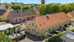 A courtyard with traditional European architecture, including buildings with tiled roofs and a central open space. - "Viivi" - 900m from the sea by Interhome (Skagen)