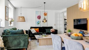 A modern living room with a sofa, coffee table, and dining area. - "Viivi" - 900m from the sea by Interhome (Skagen)