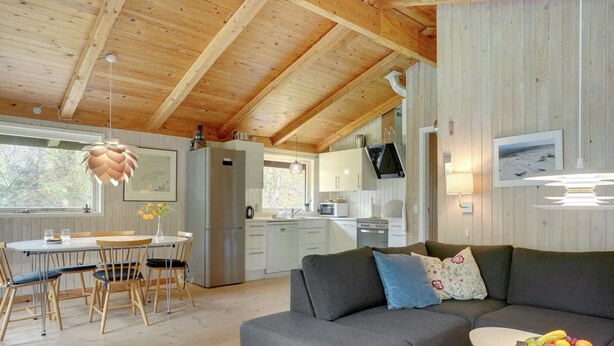 A cozy cabin interior with a dining area, kitchen, and living space. - "Thorger" - 5km from the sea by Interhome (Læsø)