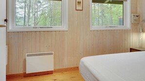 A bedroom with two windows, a radiator, and a bedside table. - "Thorger" - 5km from the sea by Interhome (Læsø)