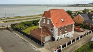 A two-story house with a red-tiled roof, a garage, and a small garden area. - "Kosara" - 50m from the sea by Interhome (Frederikshavn)
