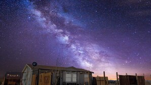 A rustic building with a satellite dish, a covered porch, and a bicycle. - Summer Relax & Unwind @ Genesis Oasis - Wifi + Spa! Pet Friendly! (Joshua Tree)