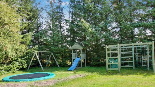 A playground with a swing set, slide, and climbing net. - "Patrik" - 1.4km from the sea by Interhome (Blåvand)