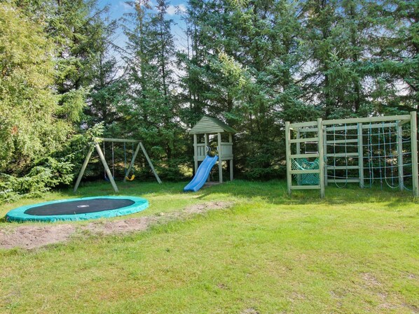 A playground with a swing set, slide, and climbing net. - "Patrik" - 1.4km from the sea by Interhome (Blåvand)