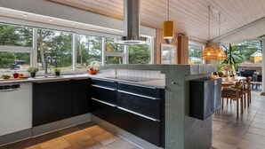 A modern kitchen with a large island, a built-in stove, and a view of the outdoors. - "Birgita" - 700m from the sea by Interhome (Vejers Strand)
