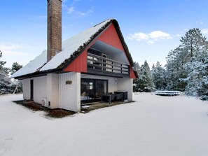 A cabin with a red roof, a chimney, and a covered outdoor seating area. - "Vendela" - 2.5km from the sea by Interhome (Rømø)
